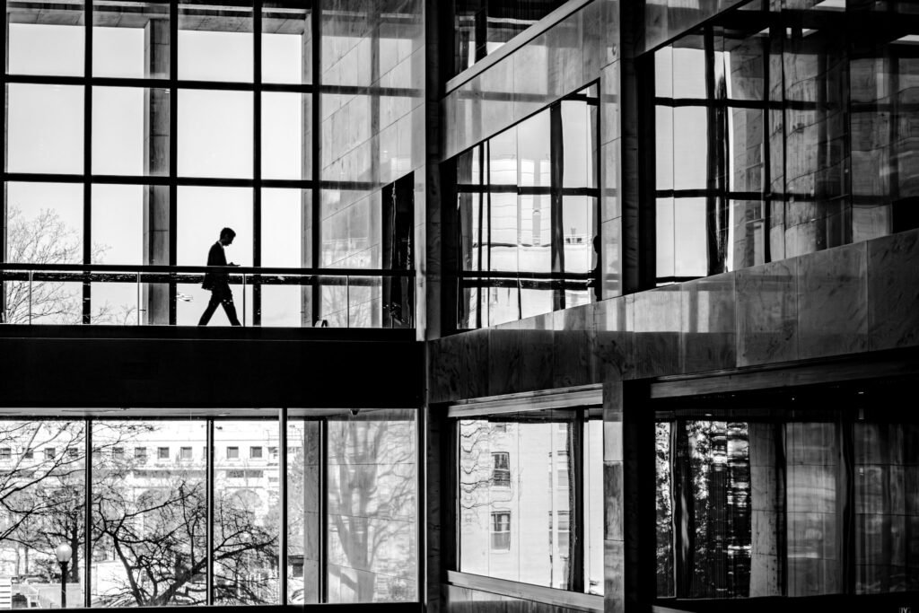 A person crossing a walkway inside a modern building