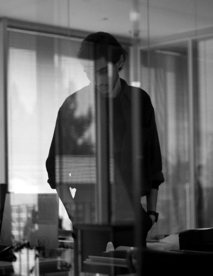 A man standing by a tall window