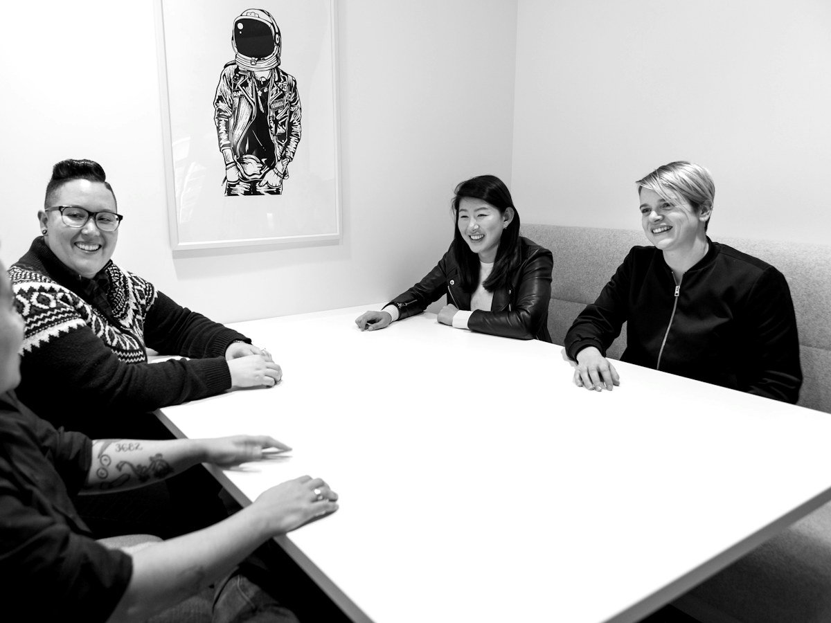 Smiling team around a white boardroom table